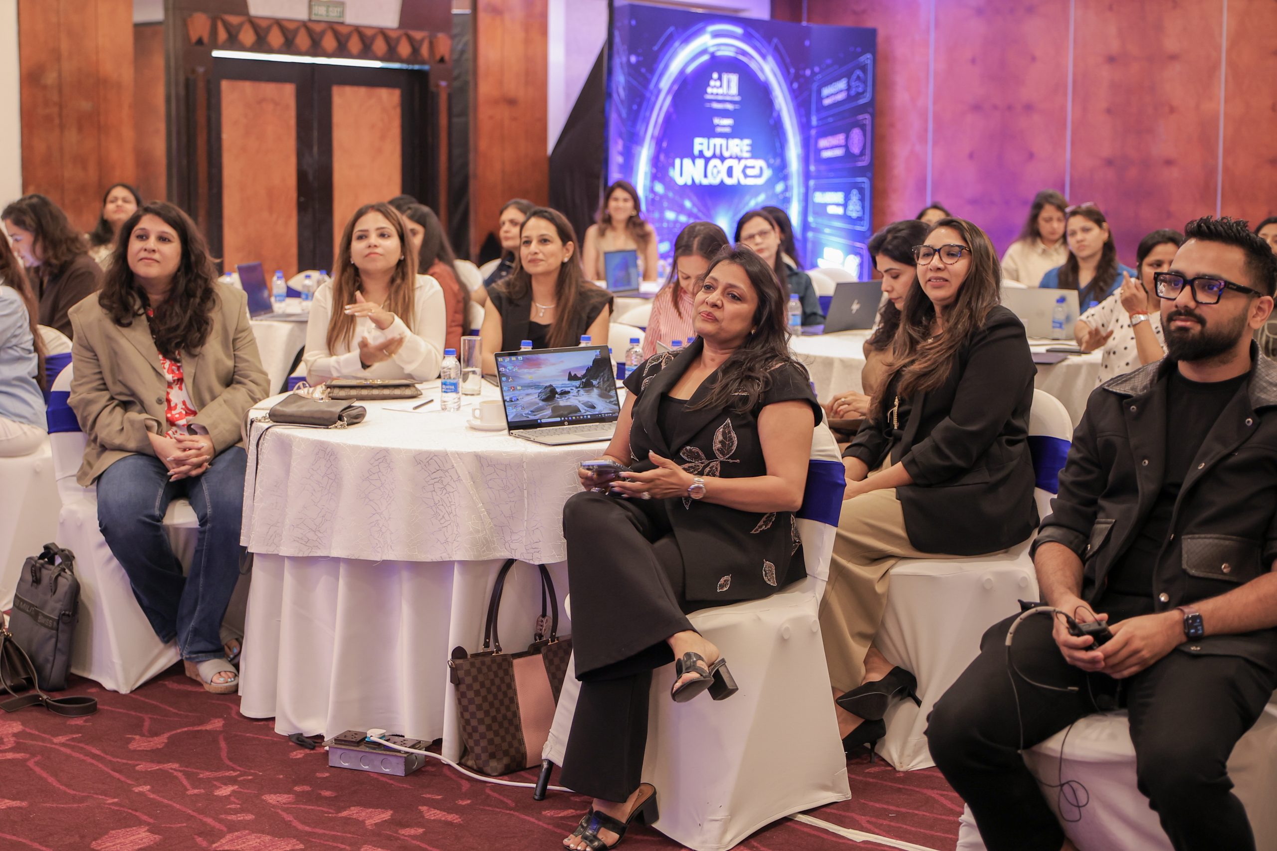 Rishi Jain and women entrepreneurs seated with laptops at the ICBI AI masterclass in Kolkata.